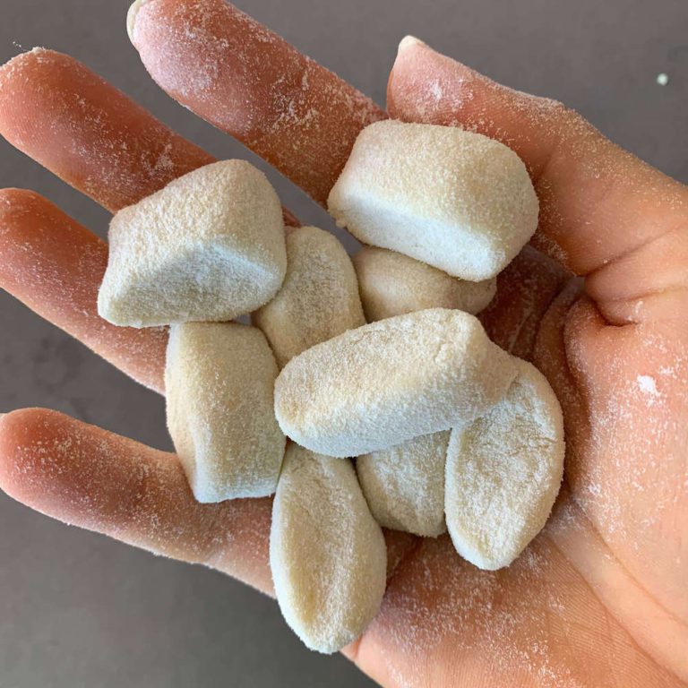 A handful of little gnocchi dusted in flour