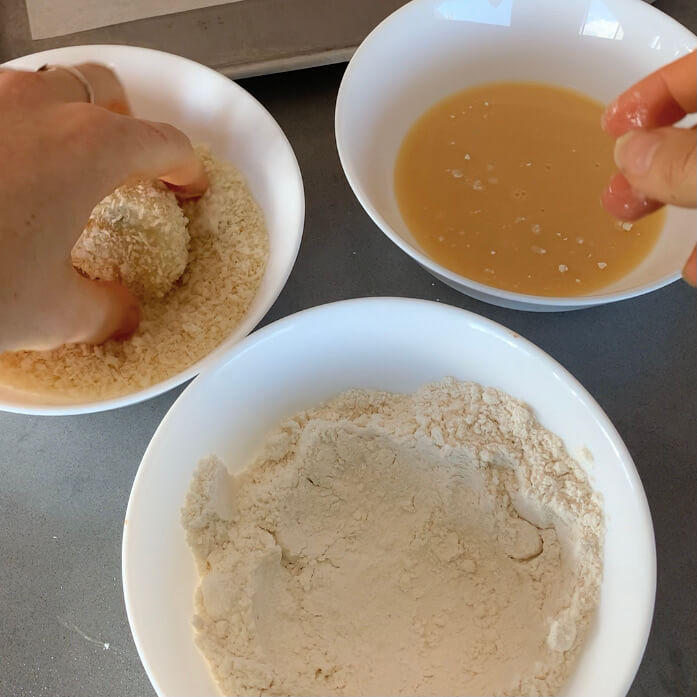Crumbing croquettes in flour, egg and breadcrumbs