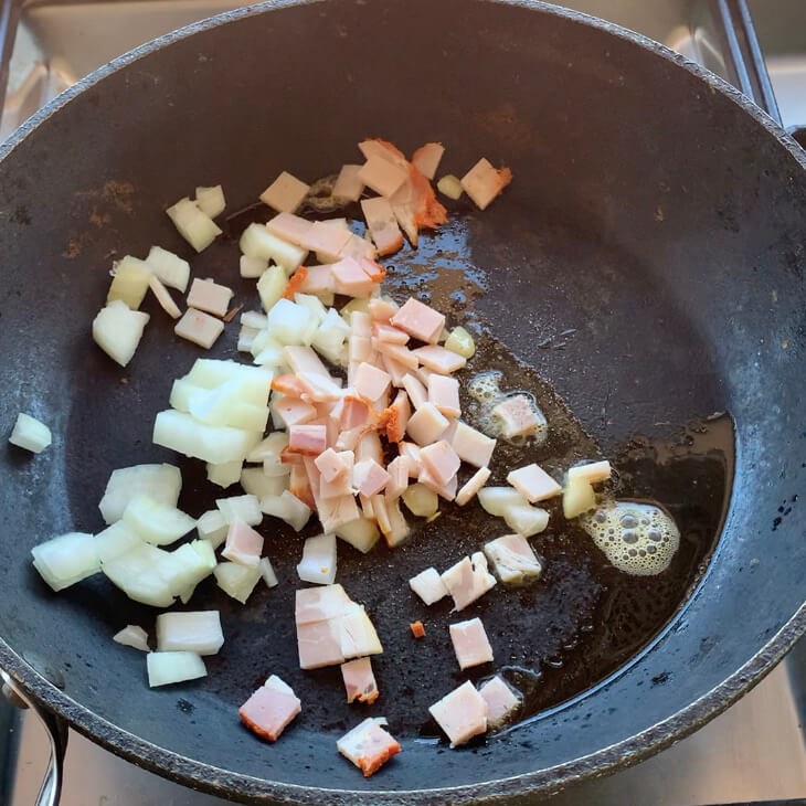 diced Onion and Bacon in a frypan