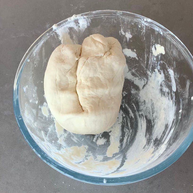 Flat bread dough in a glass bowl