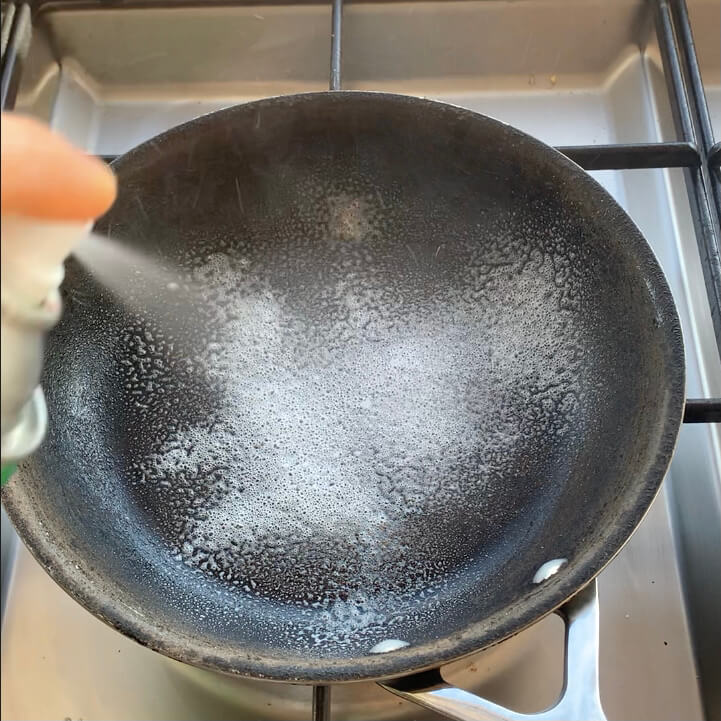 Spraying oil into a pan