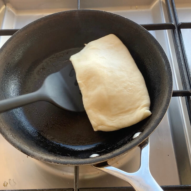 Flipping flat bread in a pan