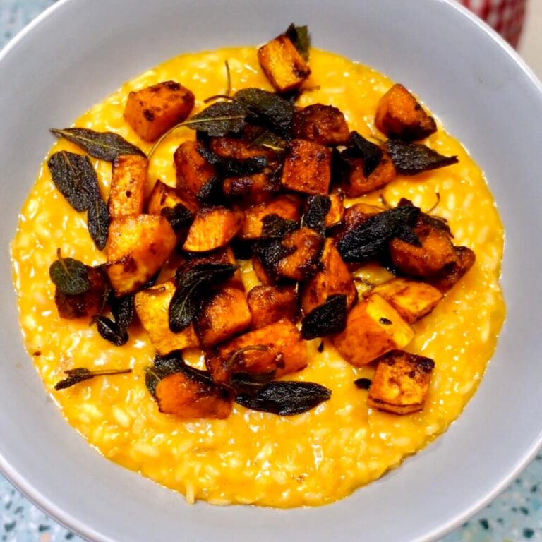 A bowl of Creamy Roasted Pumpkin Risotto with Crispy Sage and Pumpkin Pieces