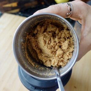 mixing breadcrumbs in a small spice grinder with a teaspoon